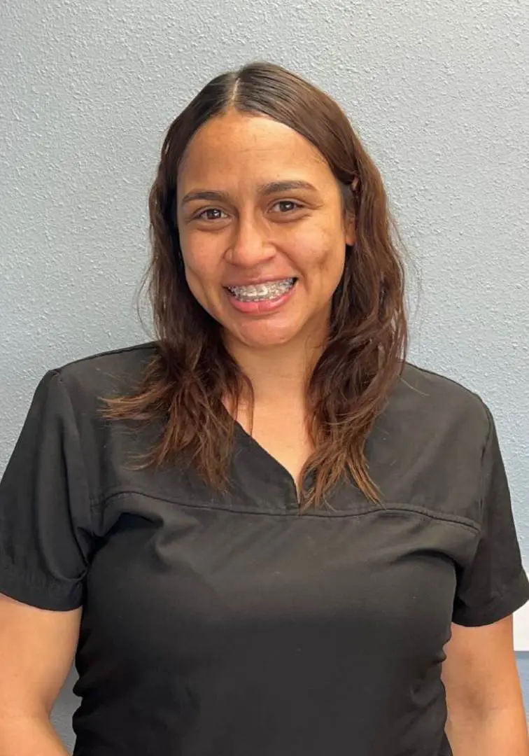 A woman in black shirt smiling for the camera.