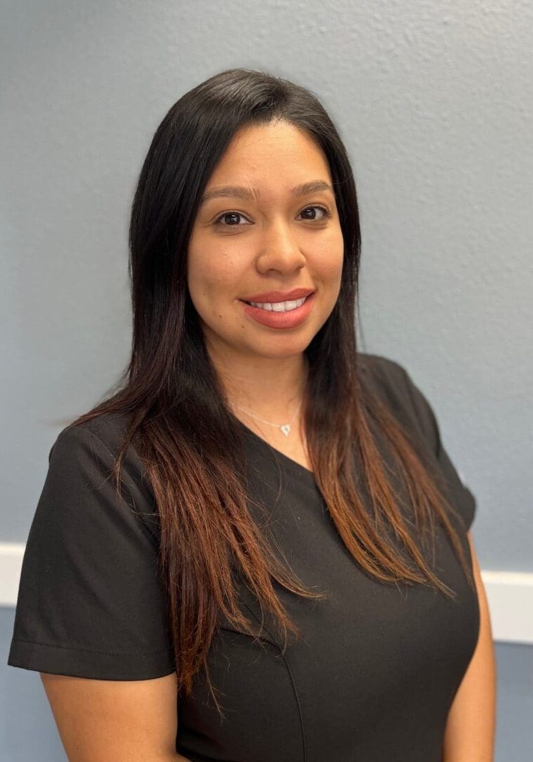 A woman in black shirt smiling for the camera.